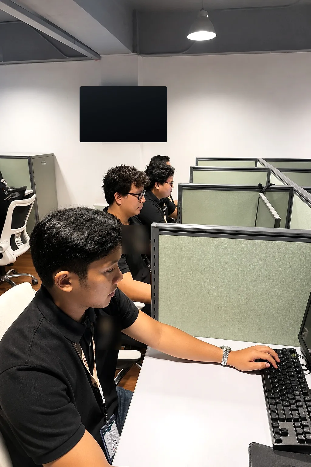 Team members focused at their computers
